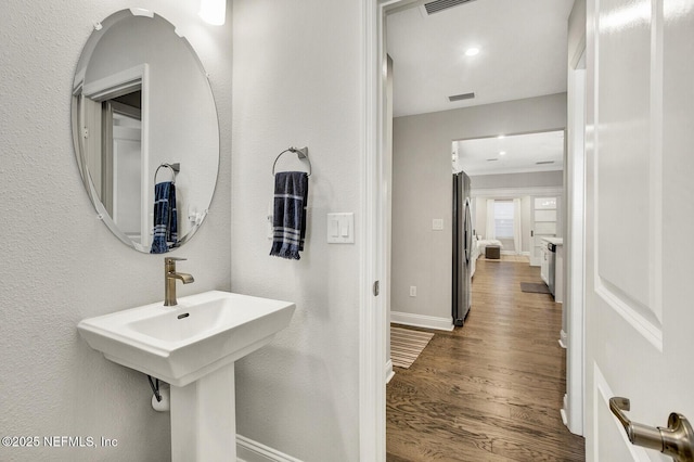 bathroom with hardwood / wood-style flooring