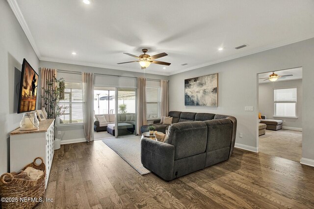 living room with ornamental molding, ceiling fan, and dark hardwood / wood-style flooring