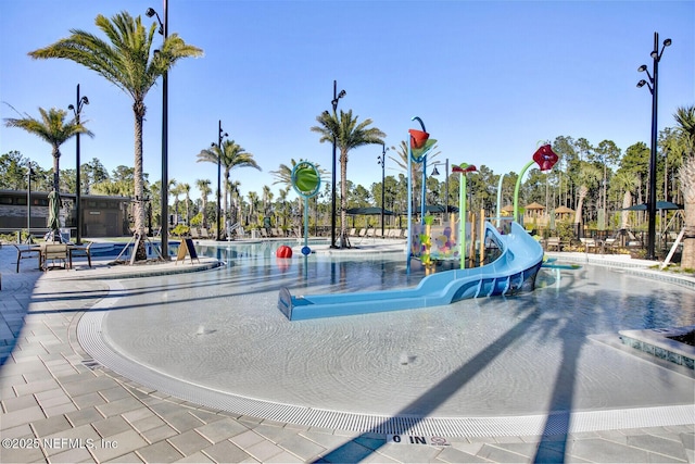 view of playground featuring a community pool