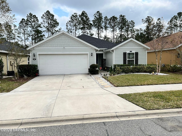 ranch-style home featuring a garage and a front lawn