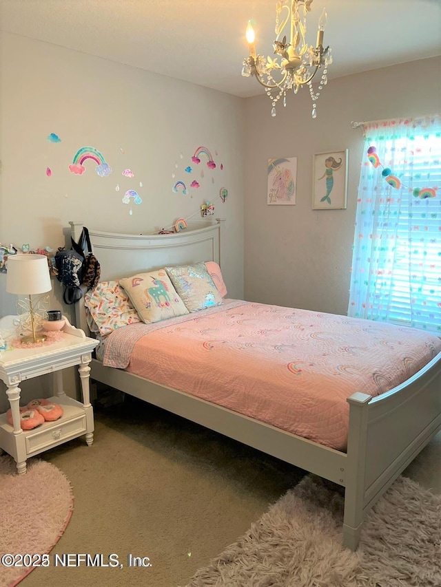 bedroom featuring carpet flooring and a chandelier