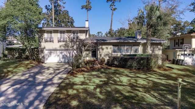 split level home with a garage and a front yard