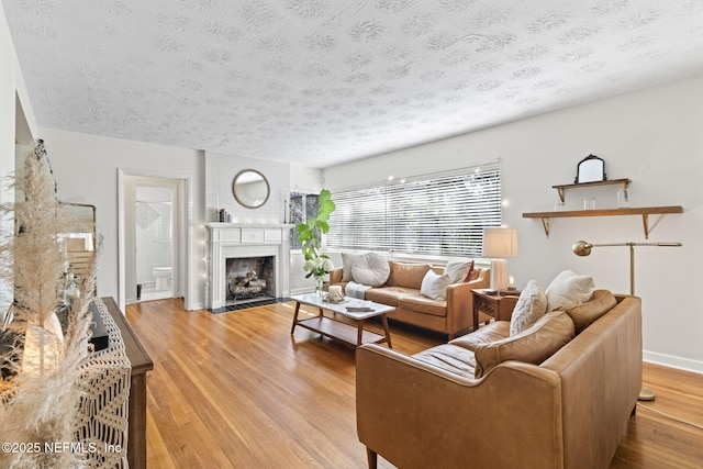 living room with light hardwood / wood-style floors and a textured ceiling