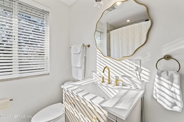 bathroom with plenty of natural light, toilet, and a shower with shower curtain