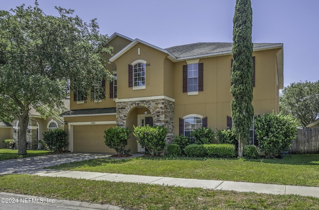 view of front facade featuring a front yard and a garage