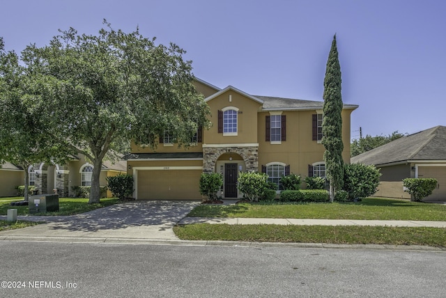 view of front of house with a garage and a front yard