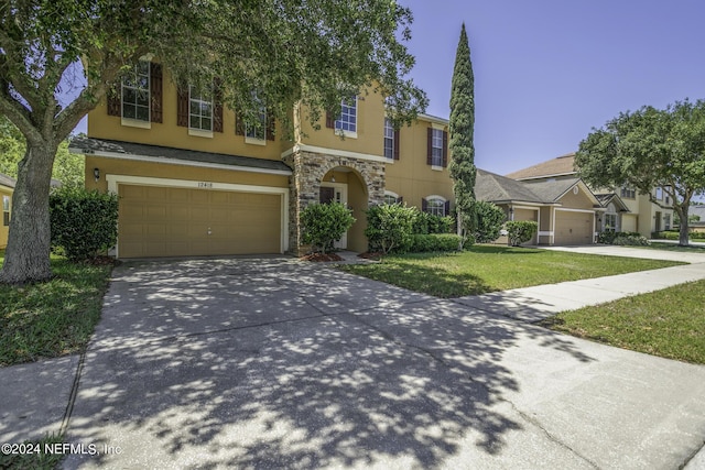 view of front of property with a garage and a front lawn