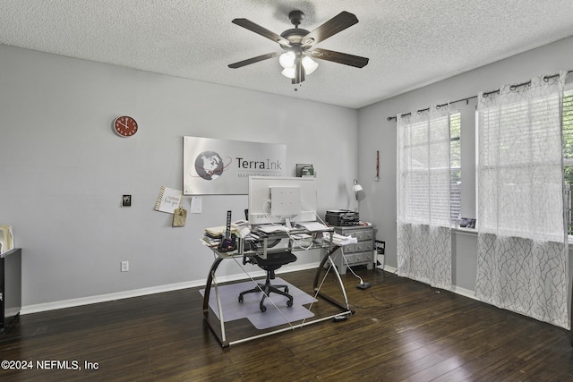 office space featuring a textured ceiling, dark wood-type flooring, and ceiling fan