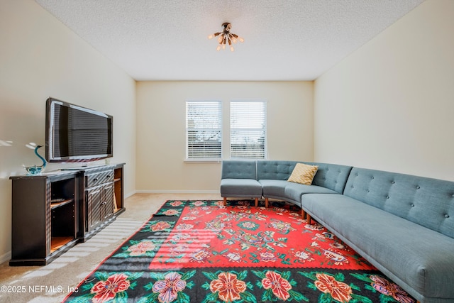 carpeted living room featuring a textured ceiling