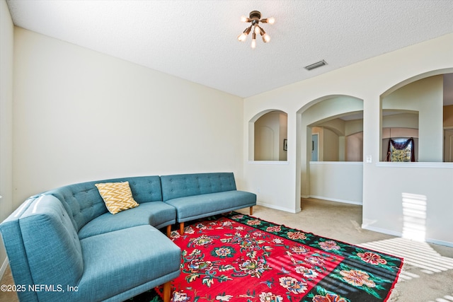 living room featuring carpet floors and a textured ceiling