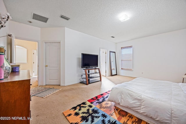 carpeted bedroom featuring a textured ceiling