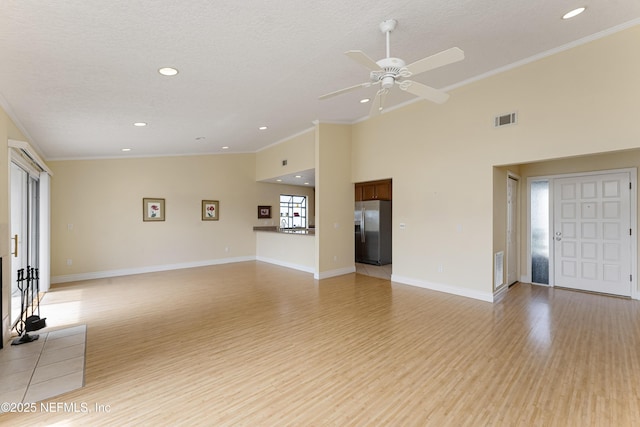 unfurnished living room featuring a textured ceiling, light wood-type flooring, ceiling fan, and crown molding