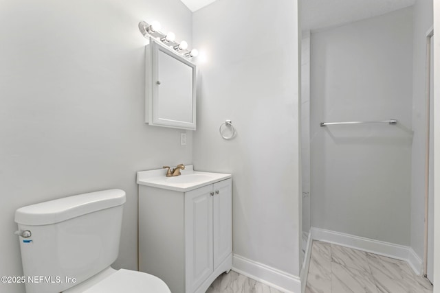 bathroom featuring toilet and vanity