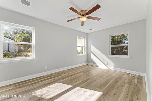 empty room featuring ceiling fan and light hardwood / wood-style flooring