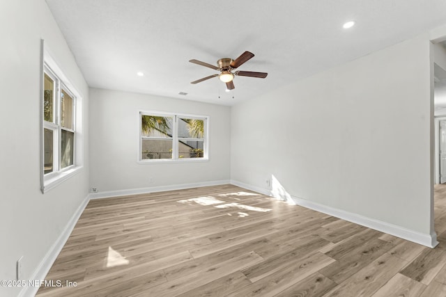 unfurnished room with ceiling fan, light hardwood / wood-style floors, and a healthy amount of sunlight