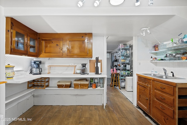 kitchen featuring sink, decorative backsplash, and light hardwood / wood-style flooring