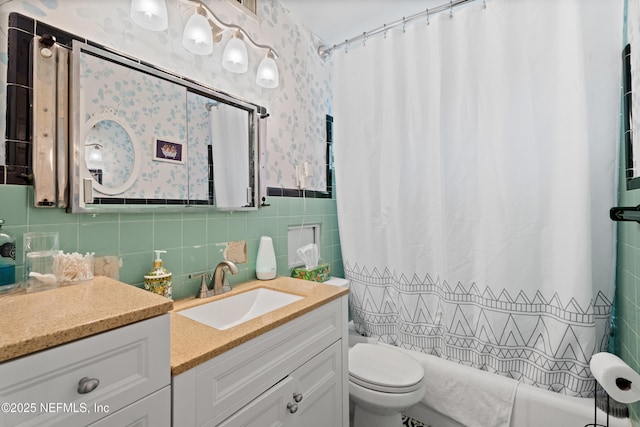 bathroom featuring vanity, toilet, and tile walls