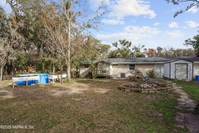 view of yard with a swimming pool side deck and a storage unit