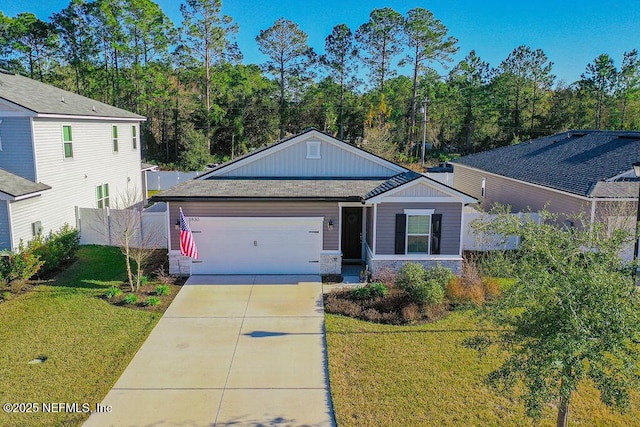 view of front of property featuring a front lawn and a garage