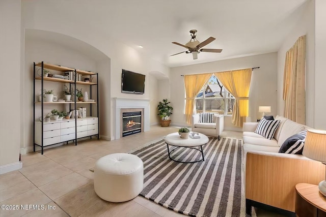 living room with light tile patterned flooring and ceiling fan