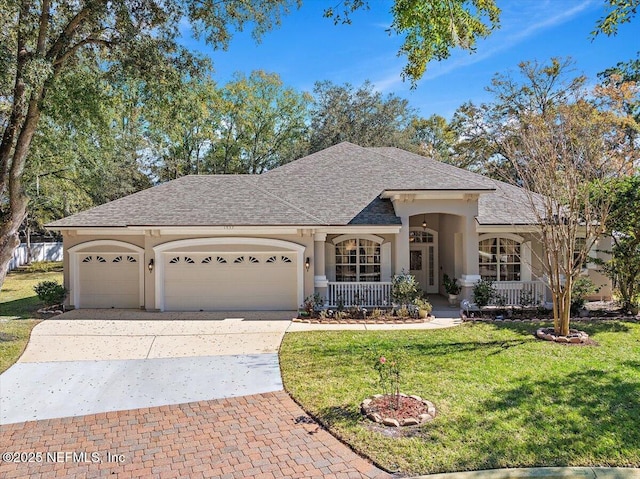 ranch-style home featuring a porch, a garage, and a front lawn