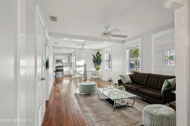 living room featuring ceiling fan and hardwood / wood-style flooring