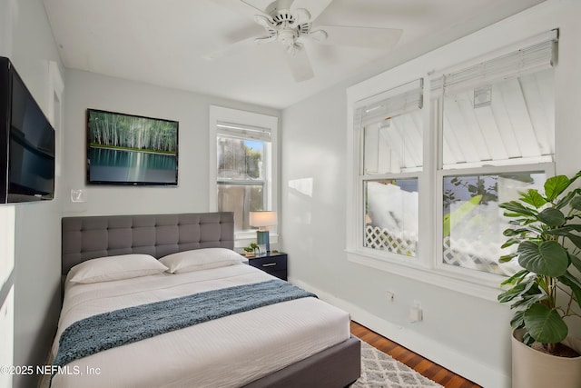 bedroom with ceiling fan and hardwood / wood-style floors