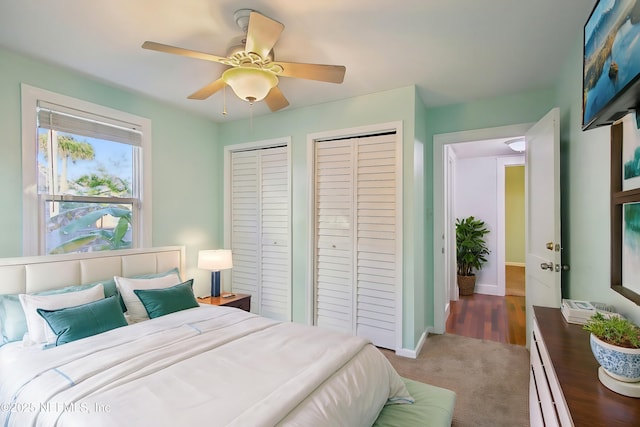 bedroom featuring carpet flooring, multiple closets, and ceiling fan