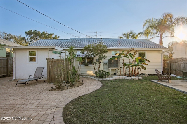 back of property featuring a patio and a lawn