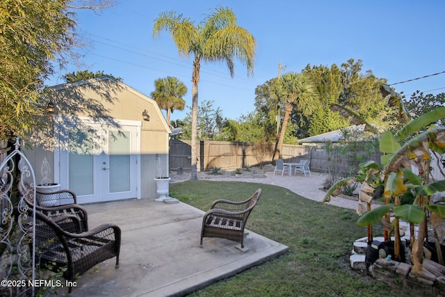 view of yard with a patio area, french doors, and an outdoor structure