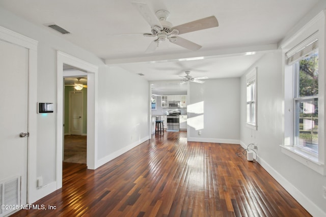 unfurnished living room featuring ceiling fan, dark hardwood / wood-style flooring, and a wealth of natural light