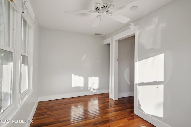 spare room featuring ceiling fan and dark hardwood / wood-style flooring