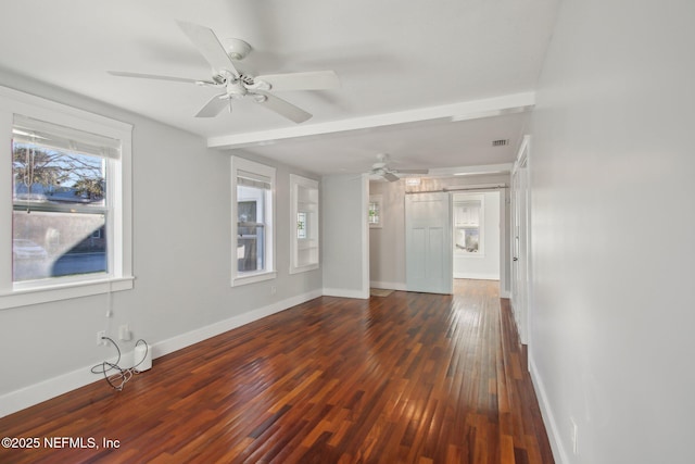 unfurnished room featuring dark hardwood / wood-style flooring, ceiling fan, and beamed ceiling