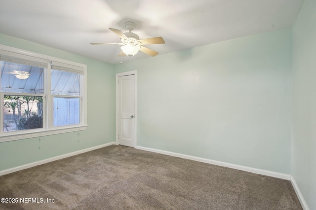 empty room with ceiling fan and carpet flooring