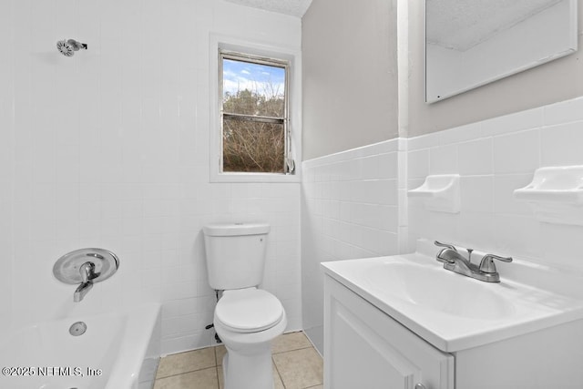 full bathroom with toilet, tile patterned flooring, tile walls, shower / tub combination, and vanity