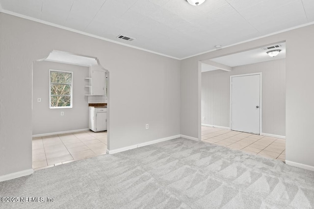 tiled spare room with ornamental molding