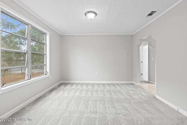 unfurnished room with light colored carpet and crown molding