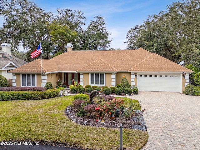 1587 Regatta Dr, Fernandina Beach, FL 32034 - ranch-style home featuring a front yard and a garage