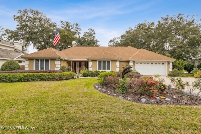 ranch-style house featuring a front yard and a garage