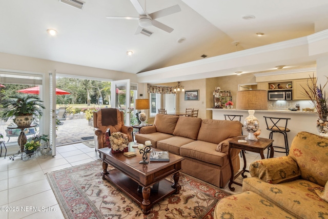 tiled living room featuring ceiling fan with notable chandelier, a wealth of natural light, vaulted ceiling, and crown molding