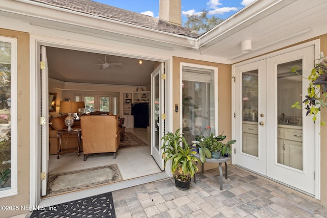 property entrance featuring ceiling fan and french doors