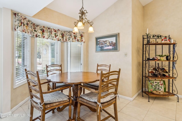 dining space with a notable chandelier, vaulted ceiling, and light tile patterned floors