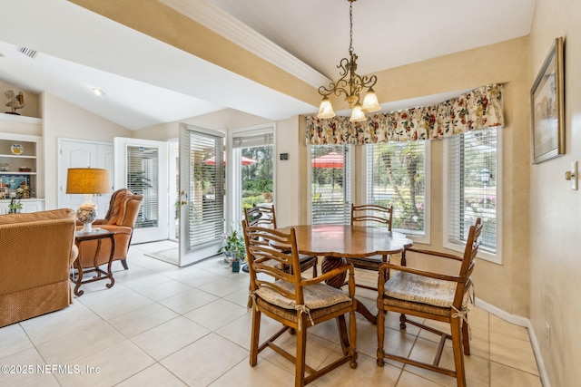 tiled dining room with a chandelier, a wealth of natural light, and built in shelves