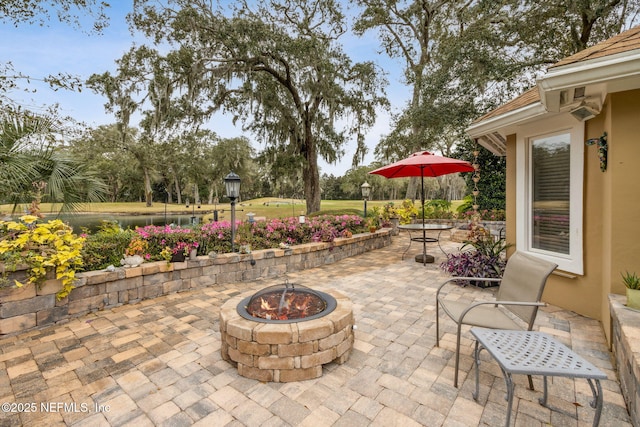 view of patio / terrace with an outdoor fire pit