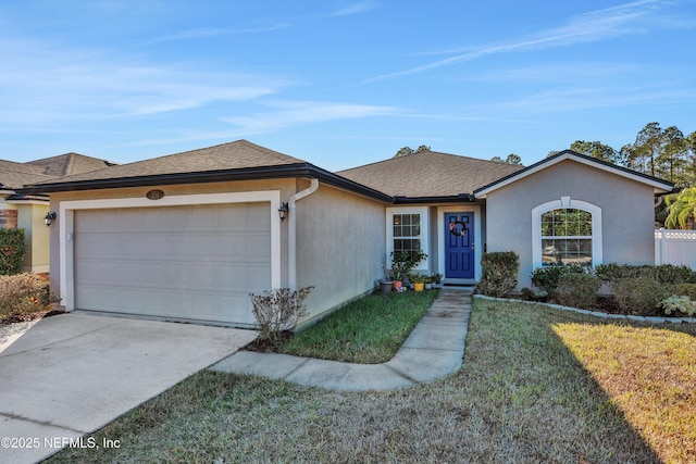 single story home with a garage and a front lawn