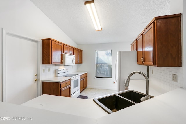 kitchen with lofted ceiling, sink, a textured ceiling, white appliances, and backsplash