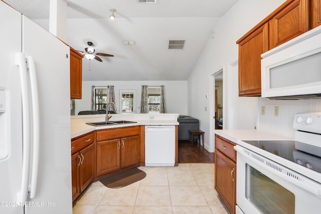 kitchen featuring sink, white appliances, ceiling fan, light tile patterned flooring, and decorative backsplash