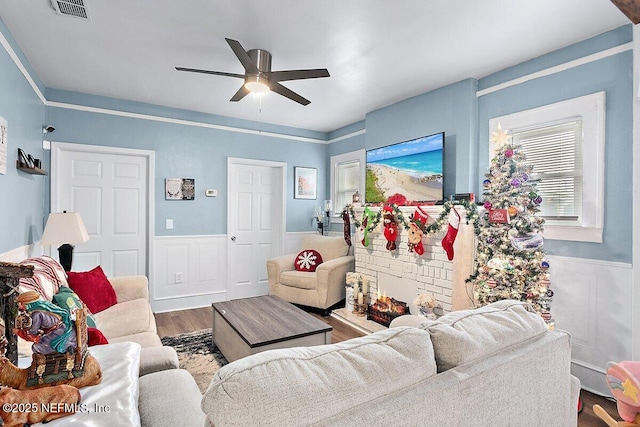 living room with ceiling fan and hardwood / wood-style floors