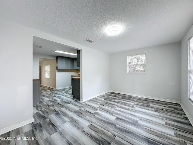 empty room featuring light hardwood / wood-style floors and a textured ceiling