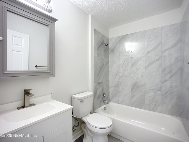 full bathroom with vanity, toilet, tiled shower / bath combo, and a textured ceiling